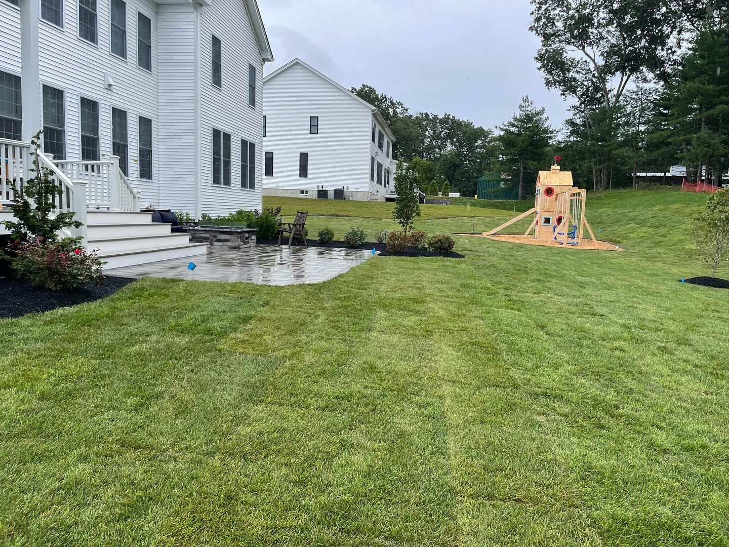 there is a playground in the backyard of a house