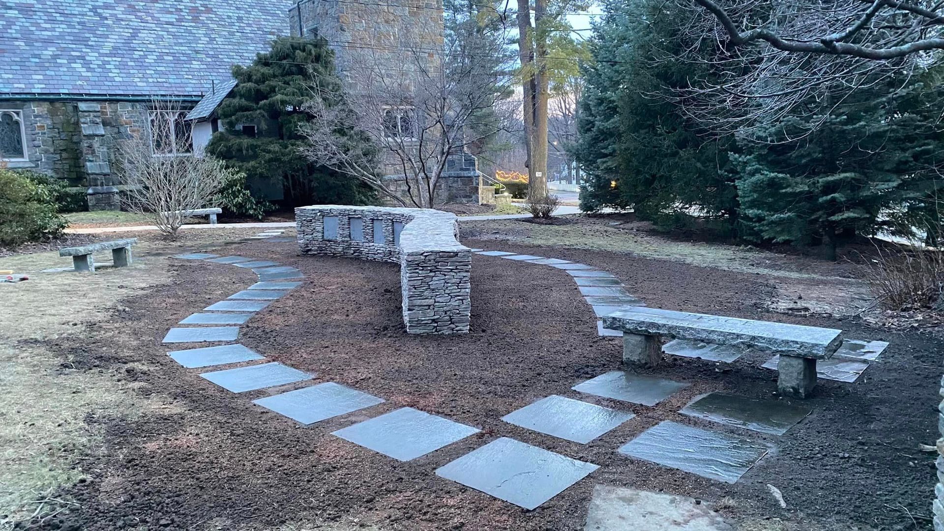 a stone walkway leading to a bench