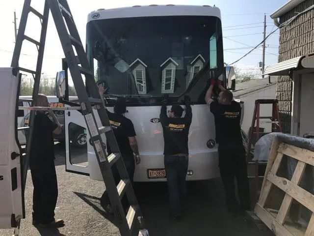 Men installing windshield