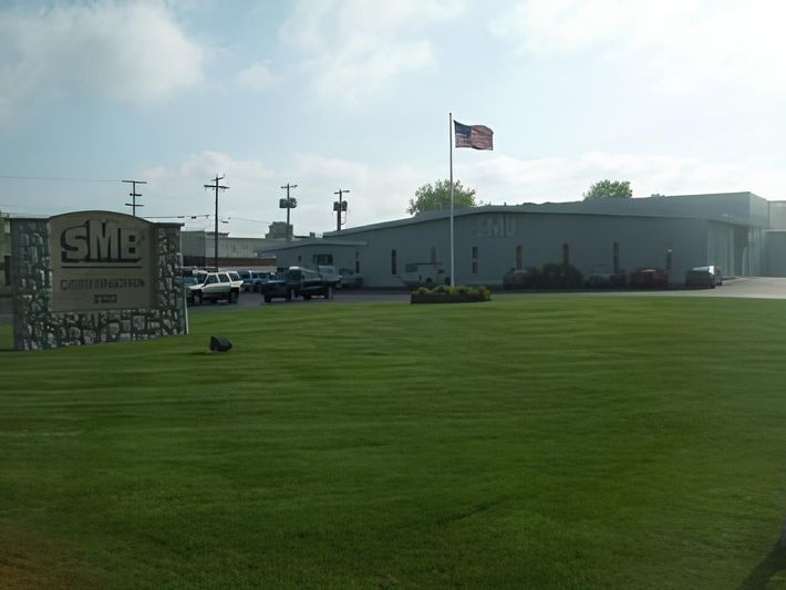 A smb sign is in front of a large building