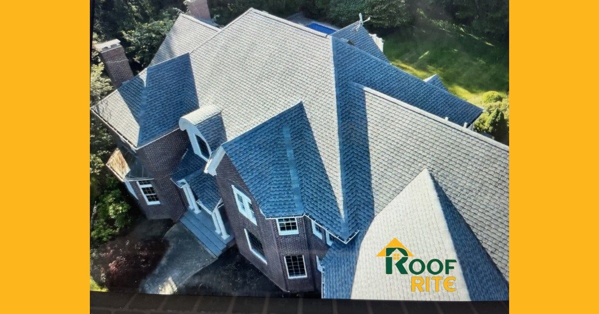 Aerial view of a house with a new grey roof. Roof Rite logo visible in the bottom right.
