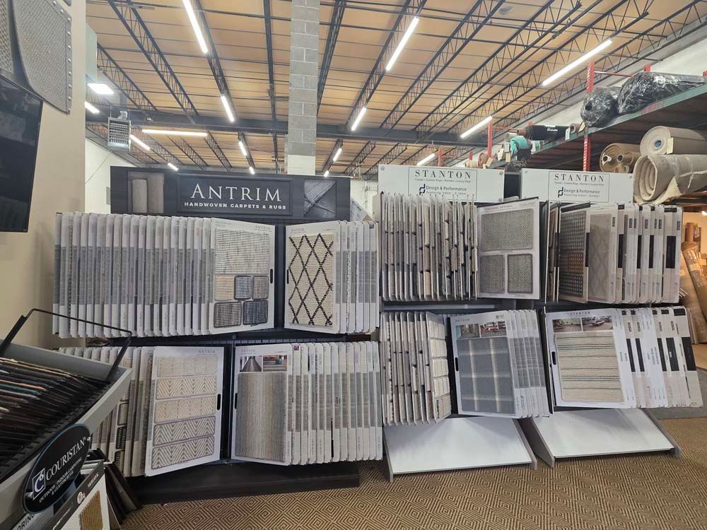 Carpet tile display in a retail store with samples of different colors and patterns.