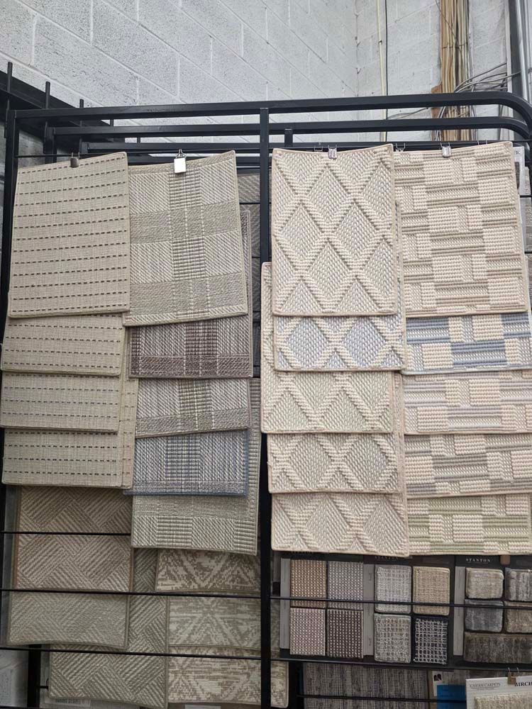 Display of various textured tiles in a showroom setting.
