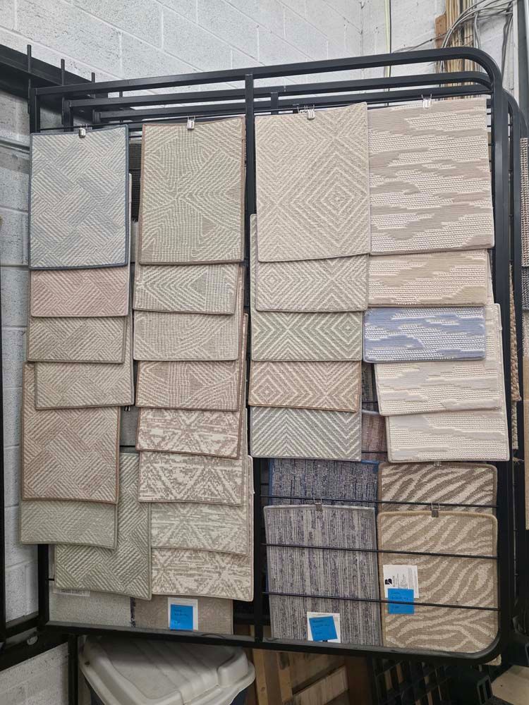 Display rack with carpet samples with various colors and patterns.