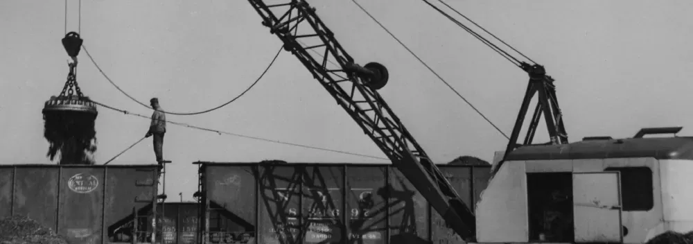 Old photo of a person working in a metal scrap yard