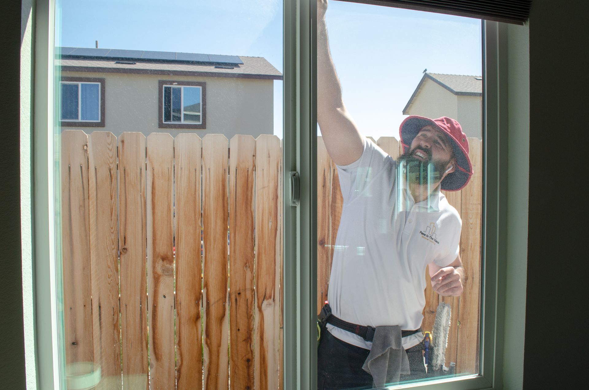 A man is cleaning a window with a cloth.