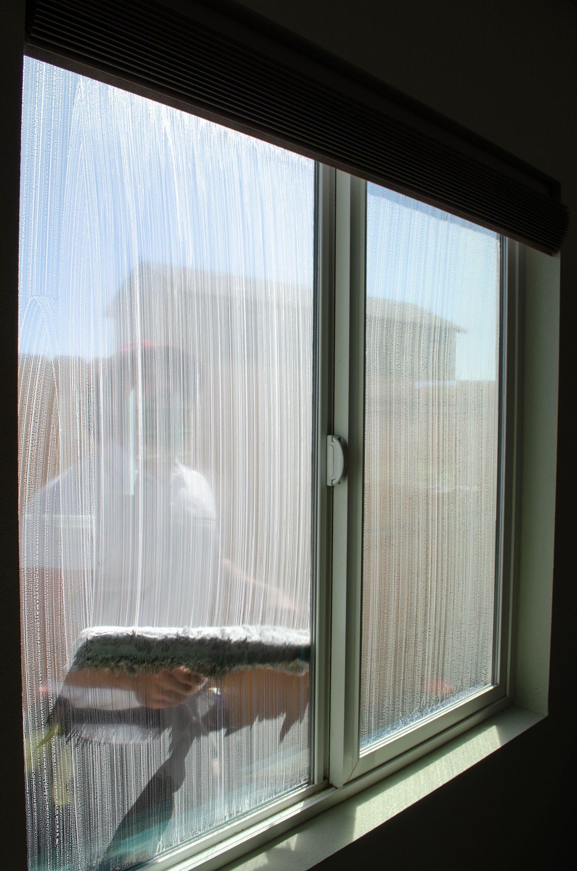 A window with a lot of water coming out of it.