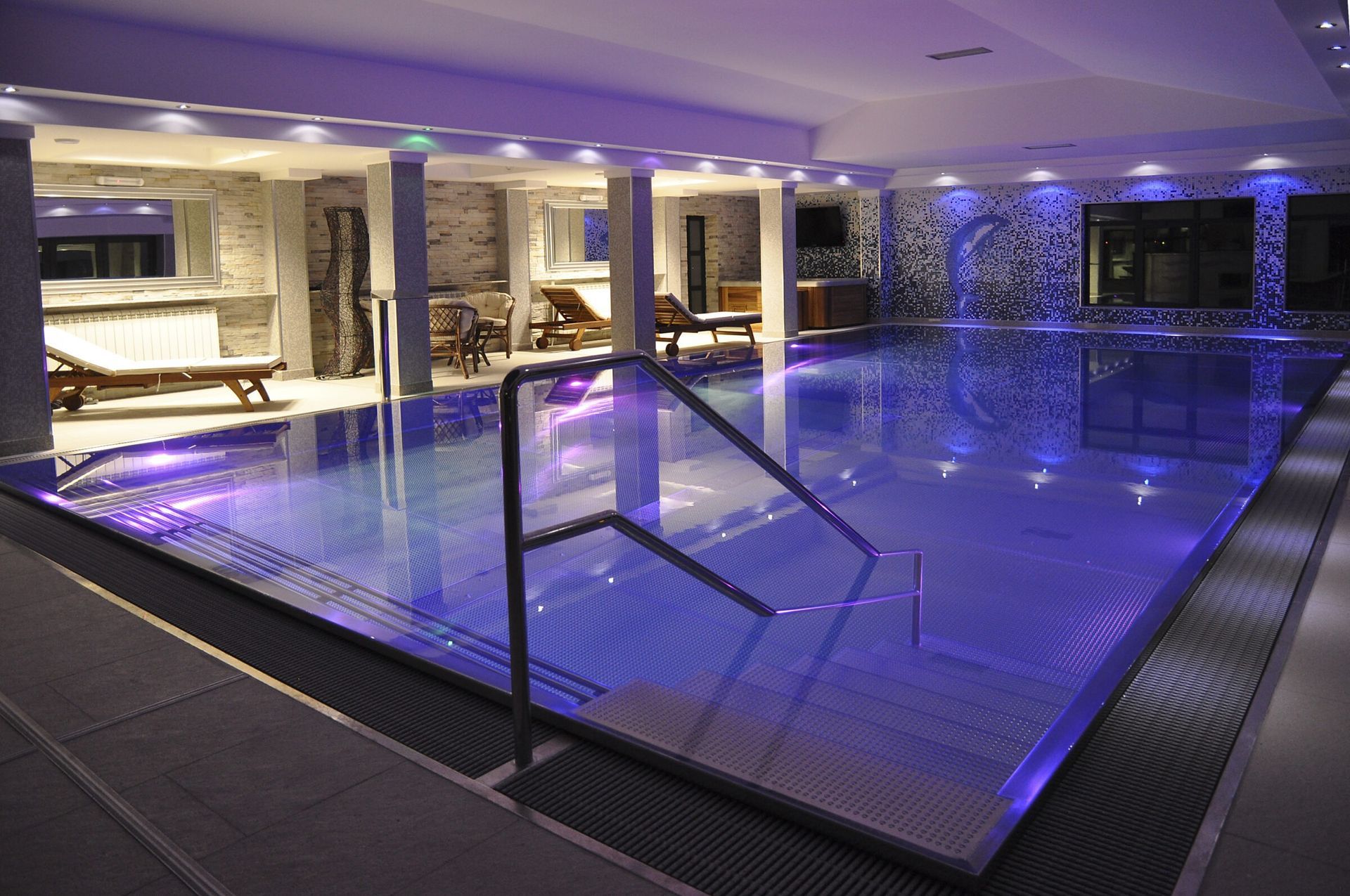 An indoor pool design with led lighting.
