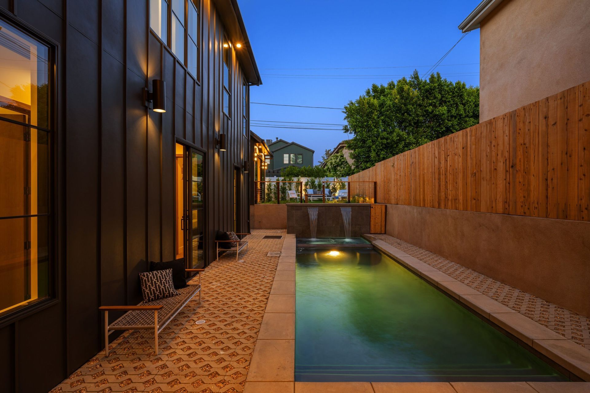 A narrower backyard pool in the evenin.