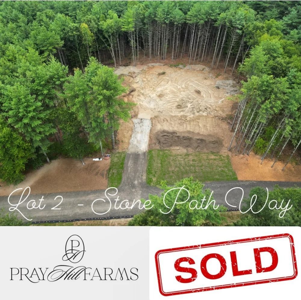 Aerial view of land clearing with road and SOLD stamp; Pray Hill Farms logo.