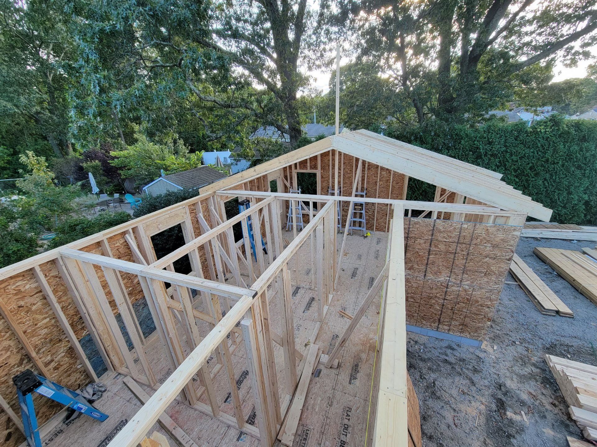 Wood-framed building under construction, exterior view with roof partially built.