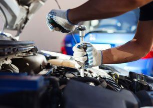 Auto tune-up, mechanic working in an auto repair garage