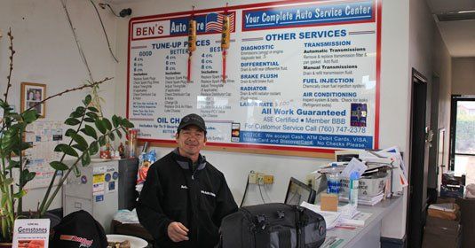 Mechanic smiling in Ben's Auto Repair shop