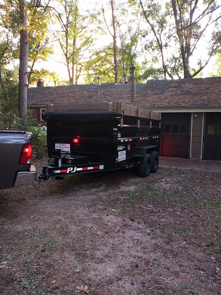 a dumpster trailer is parked in front of a house