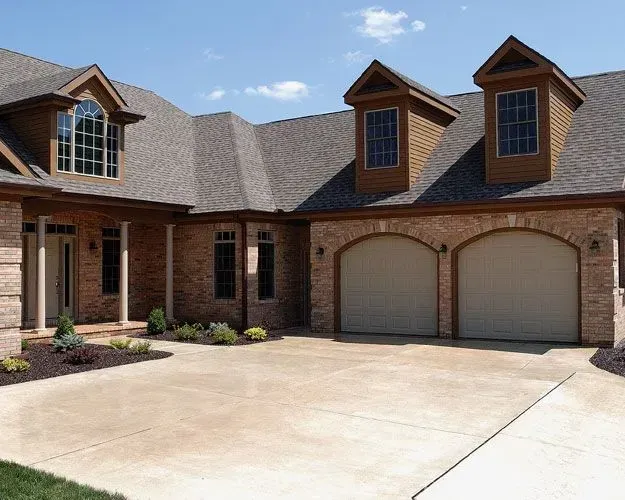 A large brick house with two garage doors