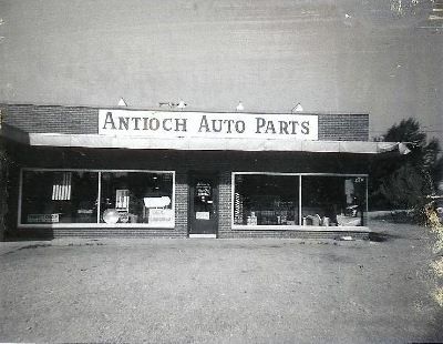 A black-and-white photo of a single-story brick building labeled 