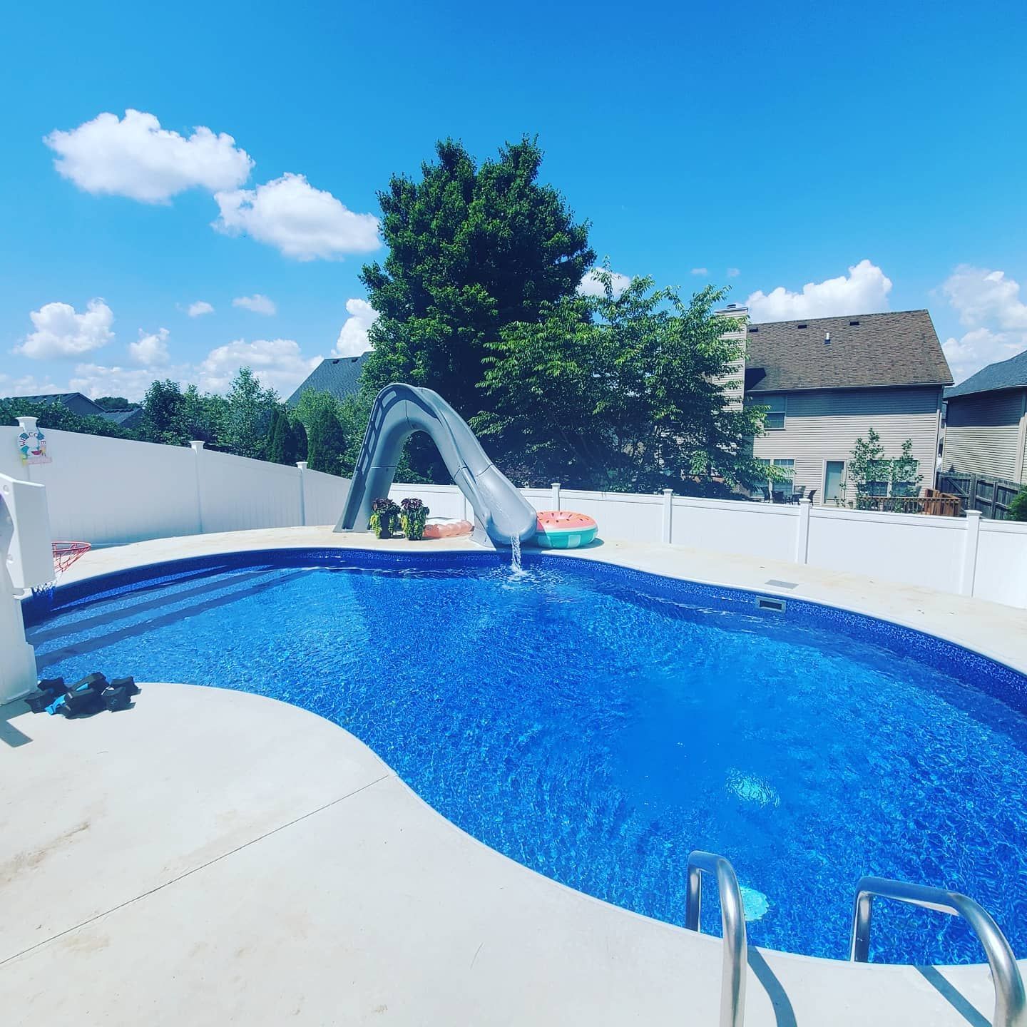 A large swimming pool with a slide attached to it
