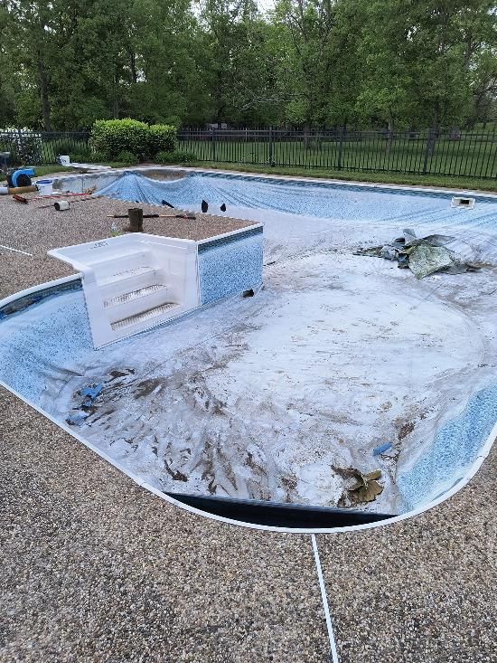 A swimming pool with a hole in it is being remodeled.