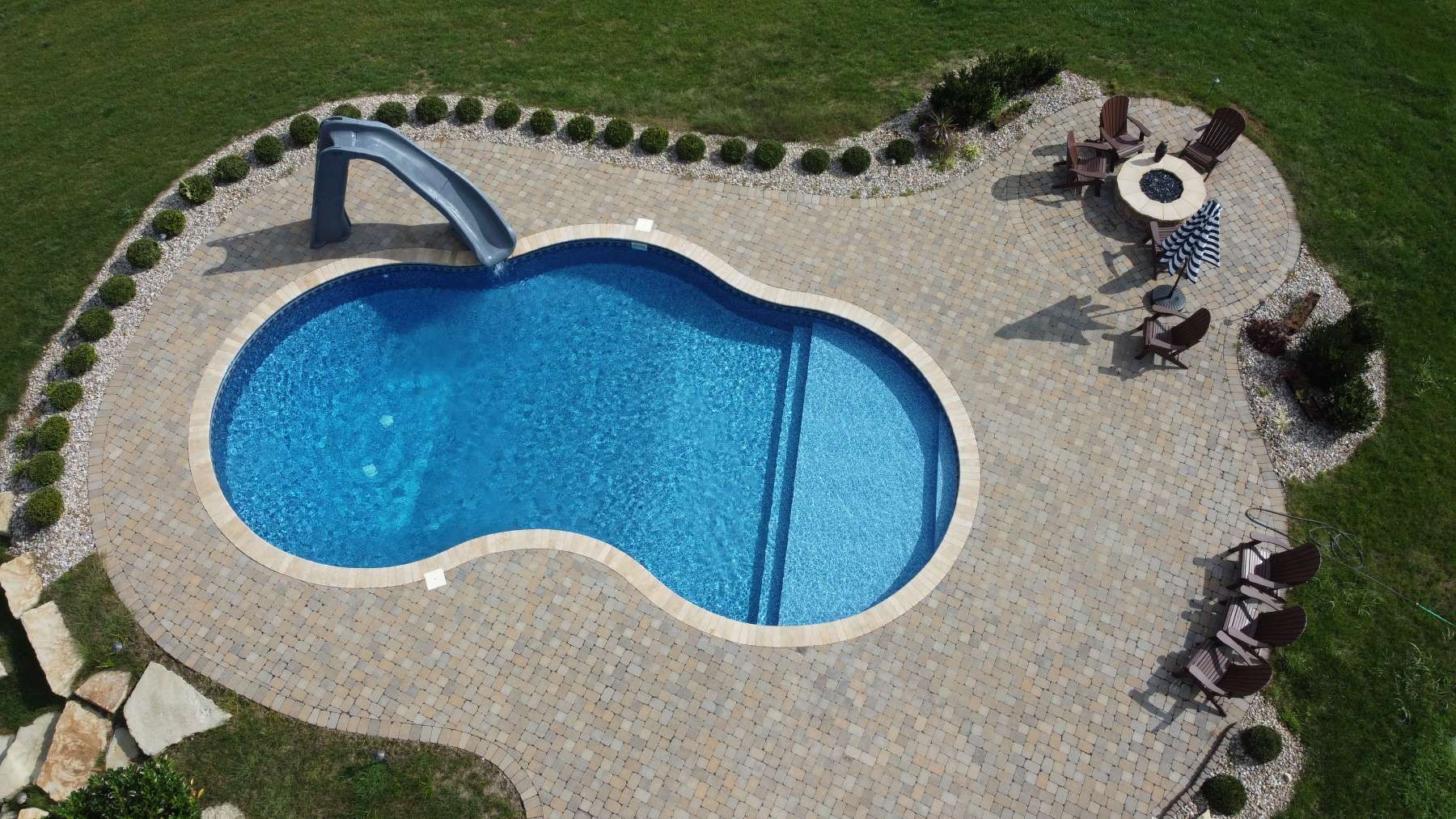 An aerial view of a large swimming pool with a slide.