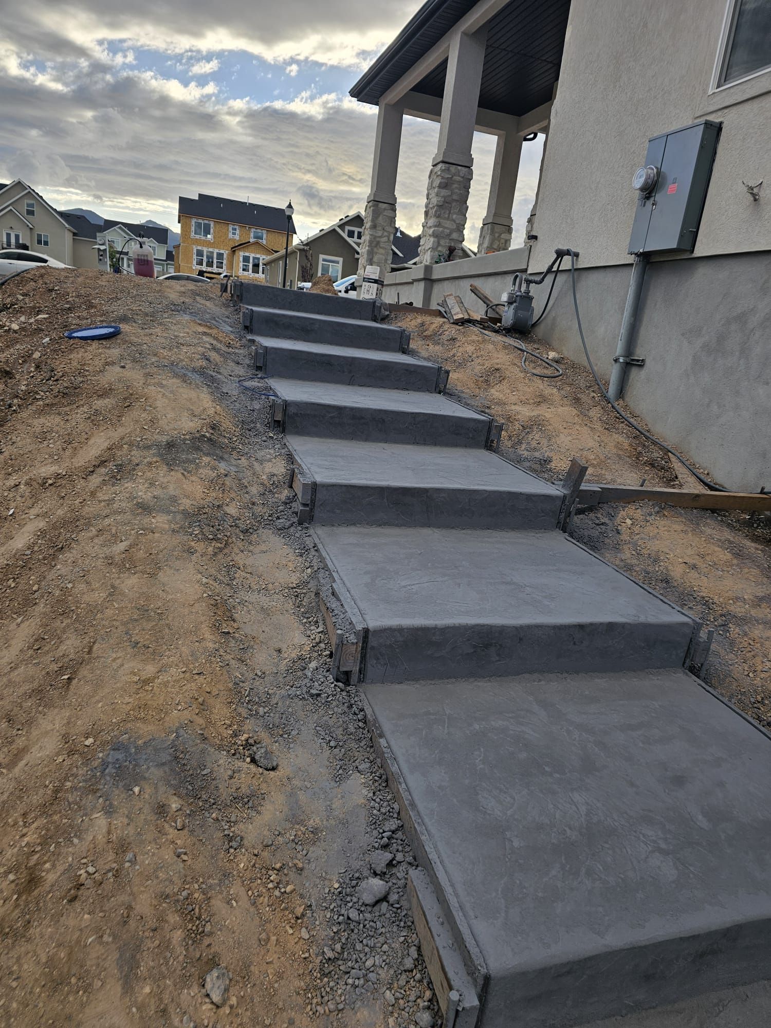 A set of concrete steps leading up to a house.