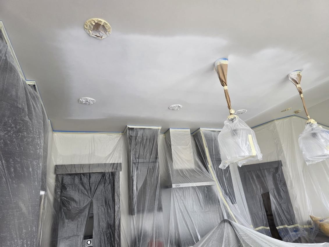 A room with a ceiling that is being painted