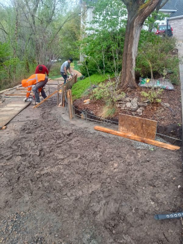 A group of men are working on a dirt road.