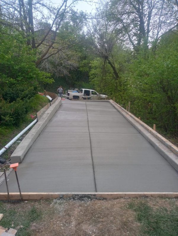 A truck is parked on the side of a concrete road.