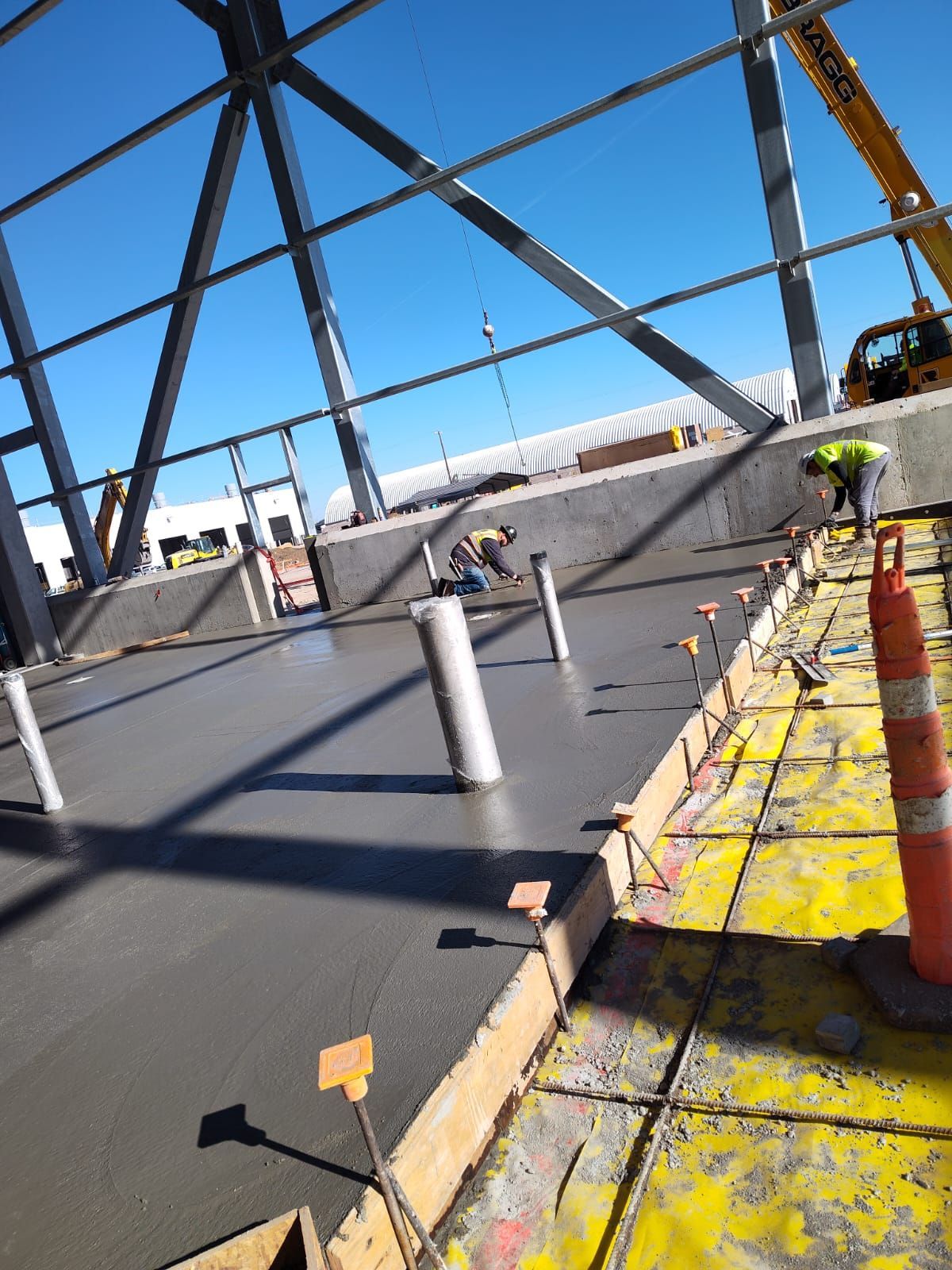 A construction site with a yellow crane in the background