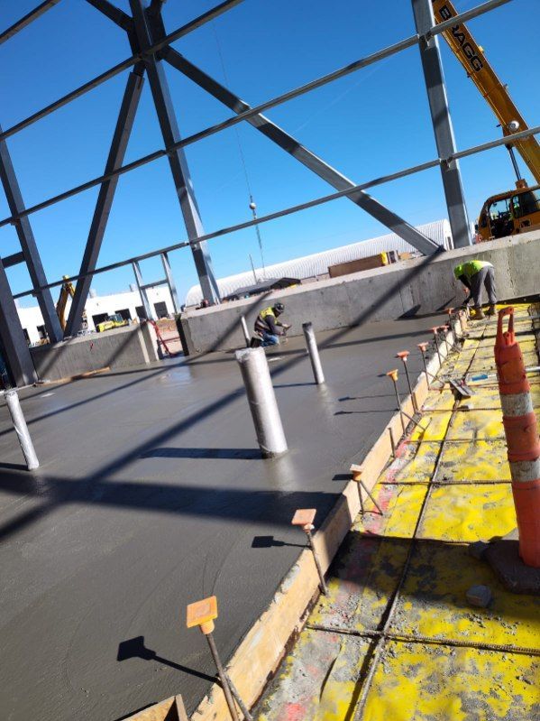 A construction site with a yellow crane in the background