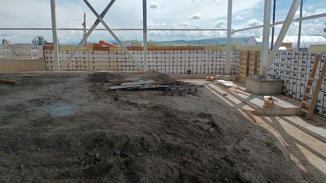 A construction site with a lot of dirt and concrete.