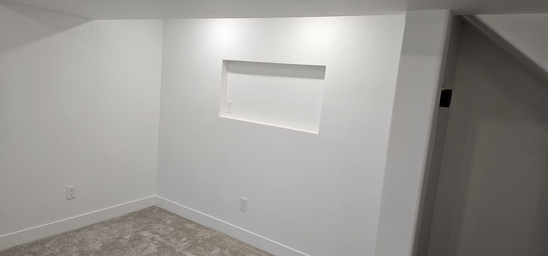 There is a window in the wall of the room.