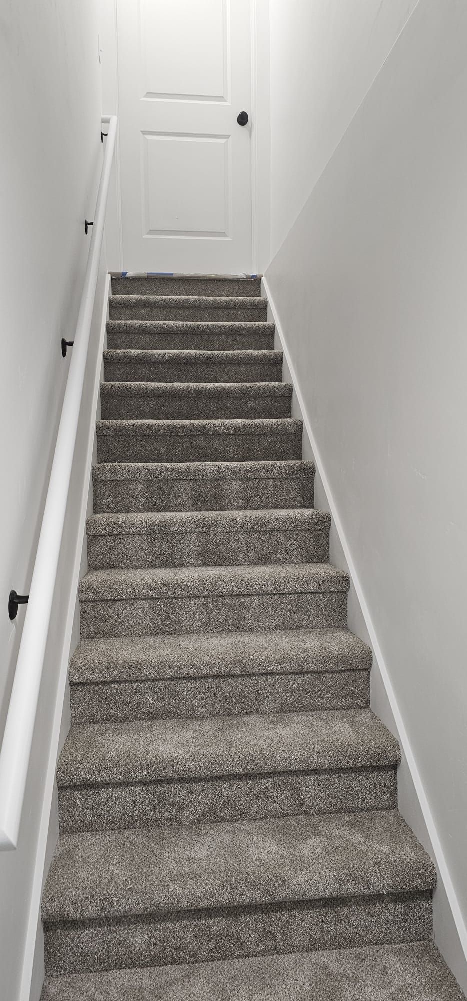 A set of stairs leading up to a basement in a house.
