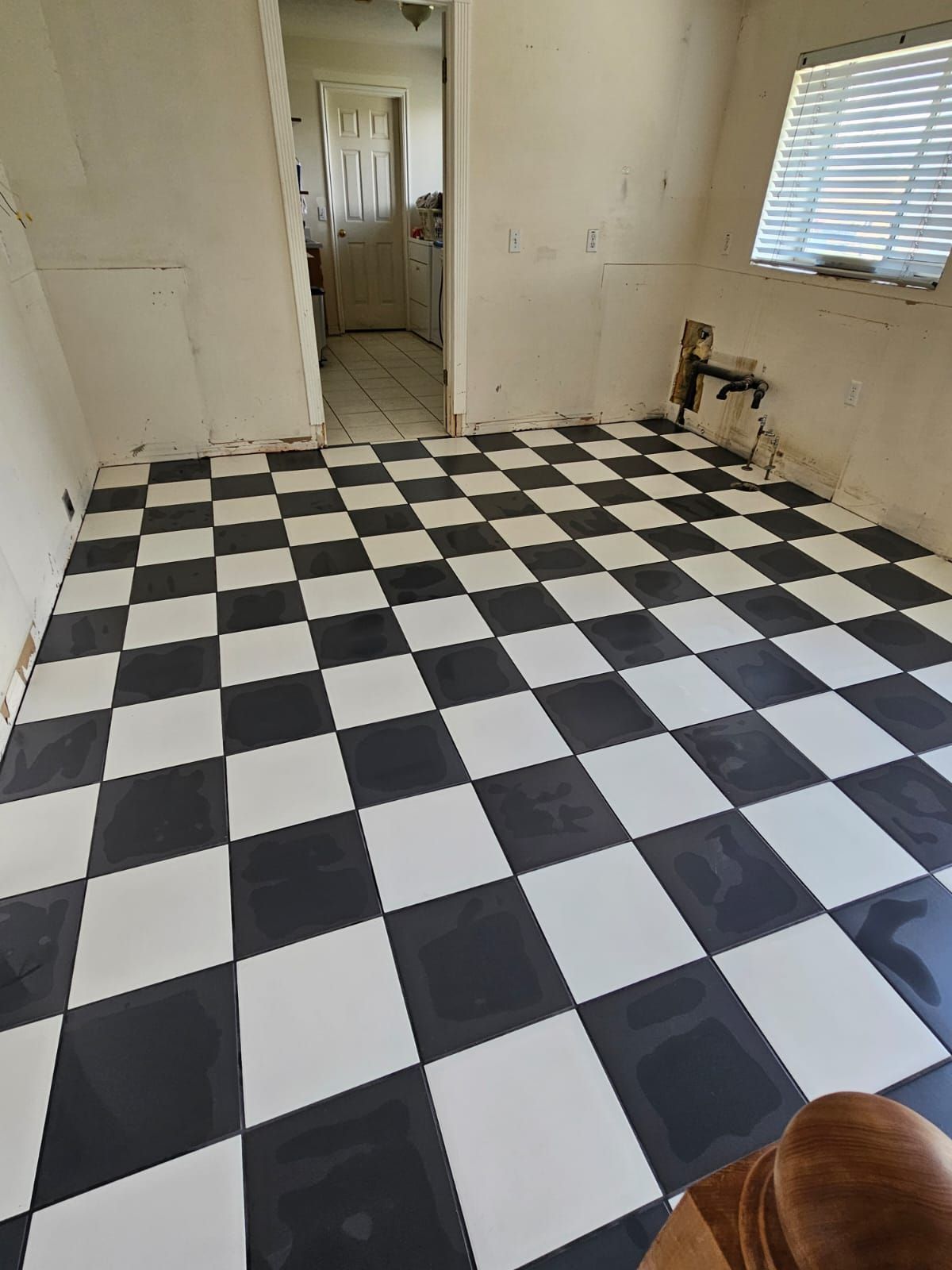 A black and white checkered floor in a room.