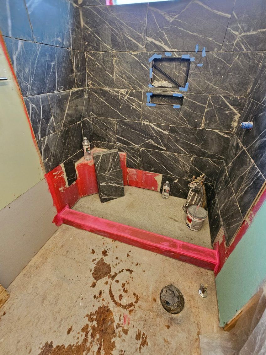 A bathroom under construction with a shower stall and a toilet.