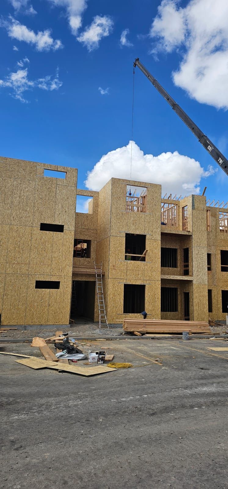 A large building under construction with a crane in the background.