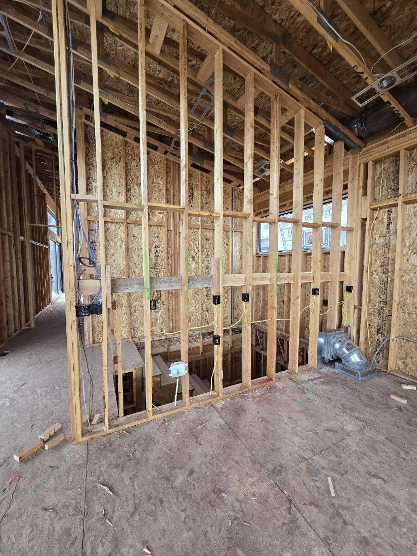 A room with wooden walls and a ceiling in a house under construction.