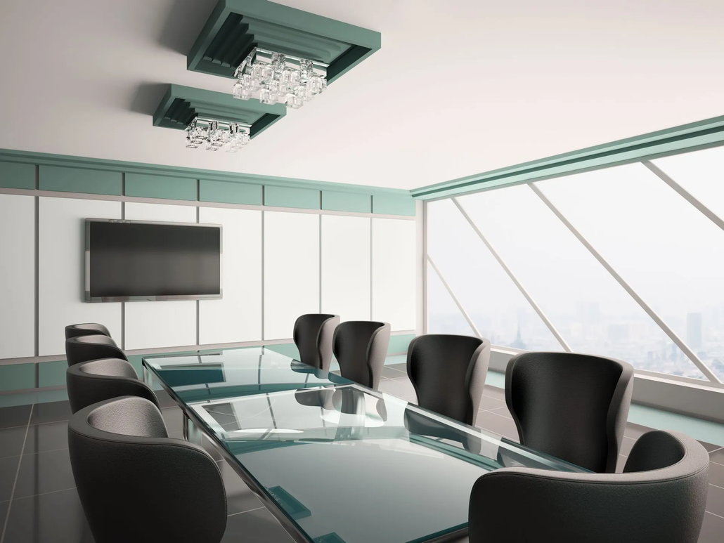 Modern conference room with glass table, black chairs, wall-mounted screen, and large windows