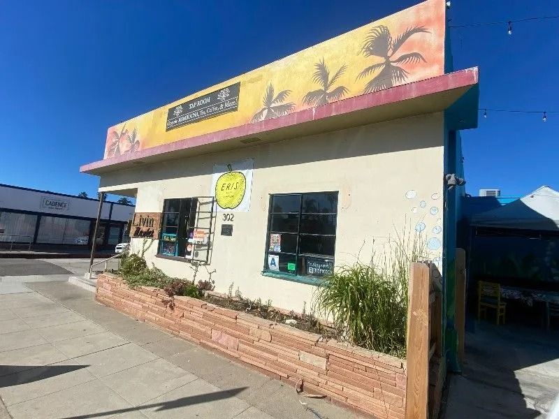 A small, tan building with a sign that reads 