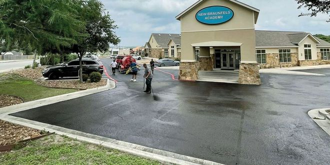 A group of people standing outside a building with the name 