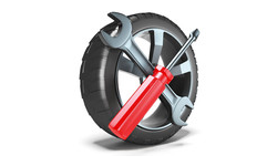 a tire with a wrench and screwdriver on it