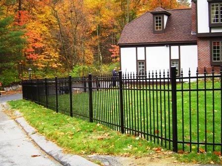 A white house with a black fence in front of it