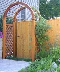 A wooden fence with a wooden arch and a wooden gate.