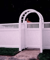 A white fence with a gate and an arch.