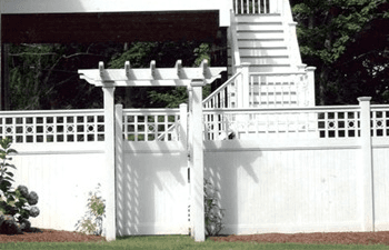 A white fence with a pergola attached to it