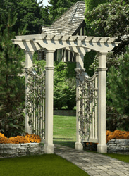 A white pergola is in the middle of a garden