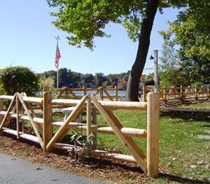 A wooden fence with an american flag in the background