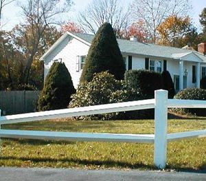 A white house with a white fence in front of it