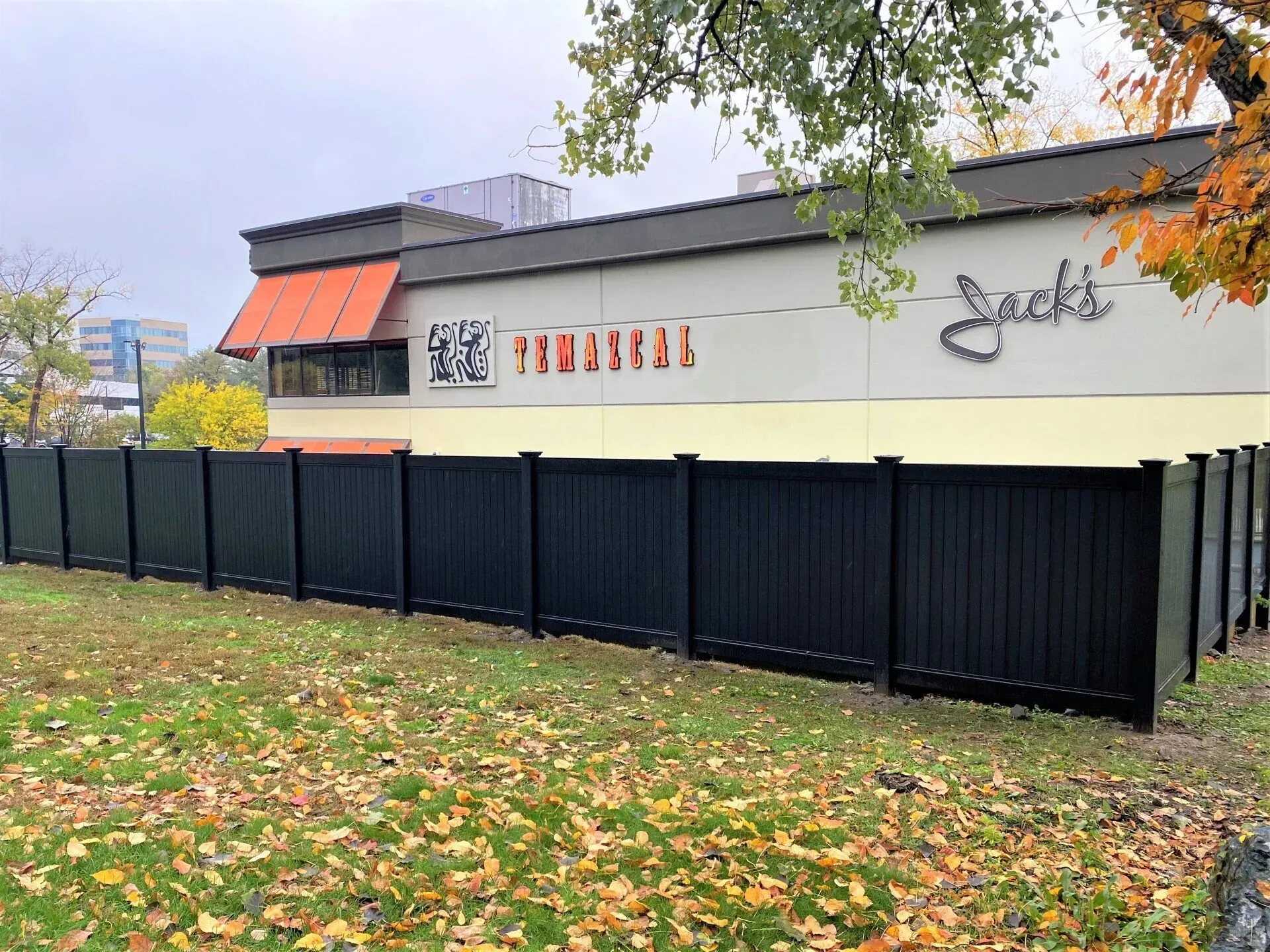 A large building with a black fence in front of it.