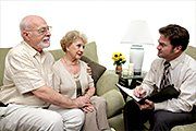Insurance advisor advising senior couple