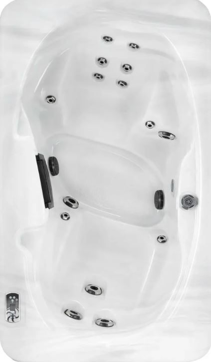 Overhead view of a white, oval-shaped hot tub with several jets, controls, and seats.